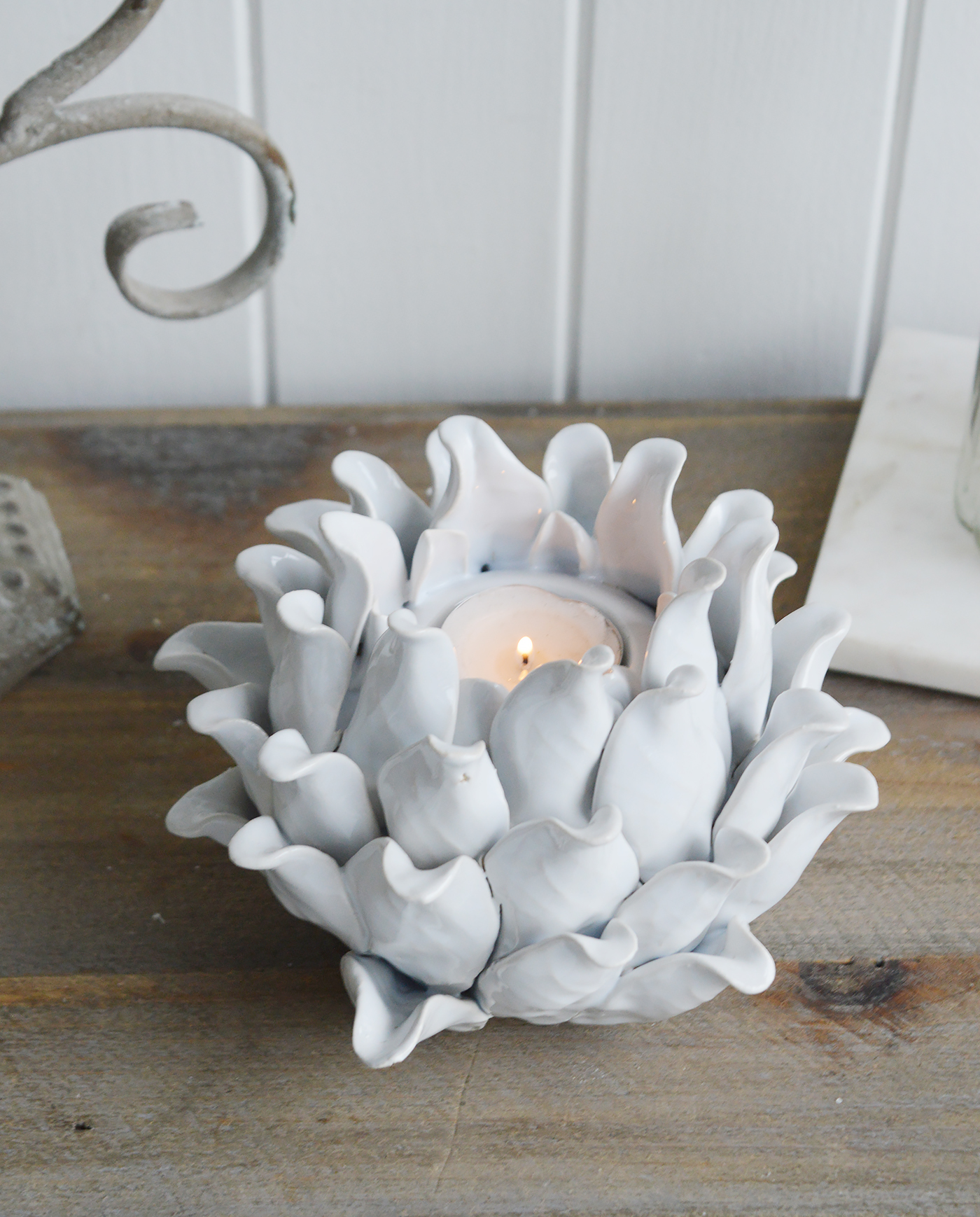 A white flower tea light holder from The White Lighthouse furniture and accessories. New England interiors. Home decor and furniture for coastal, country and city homes